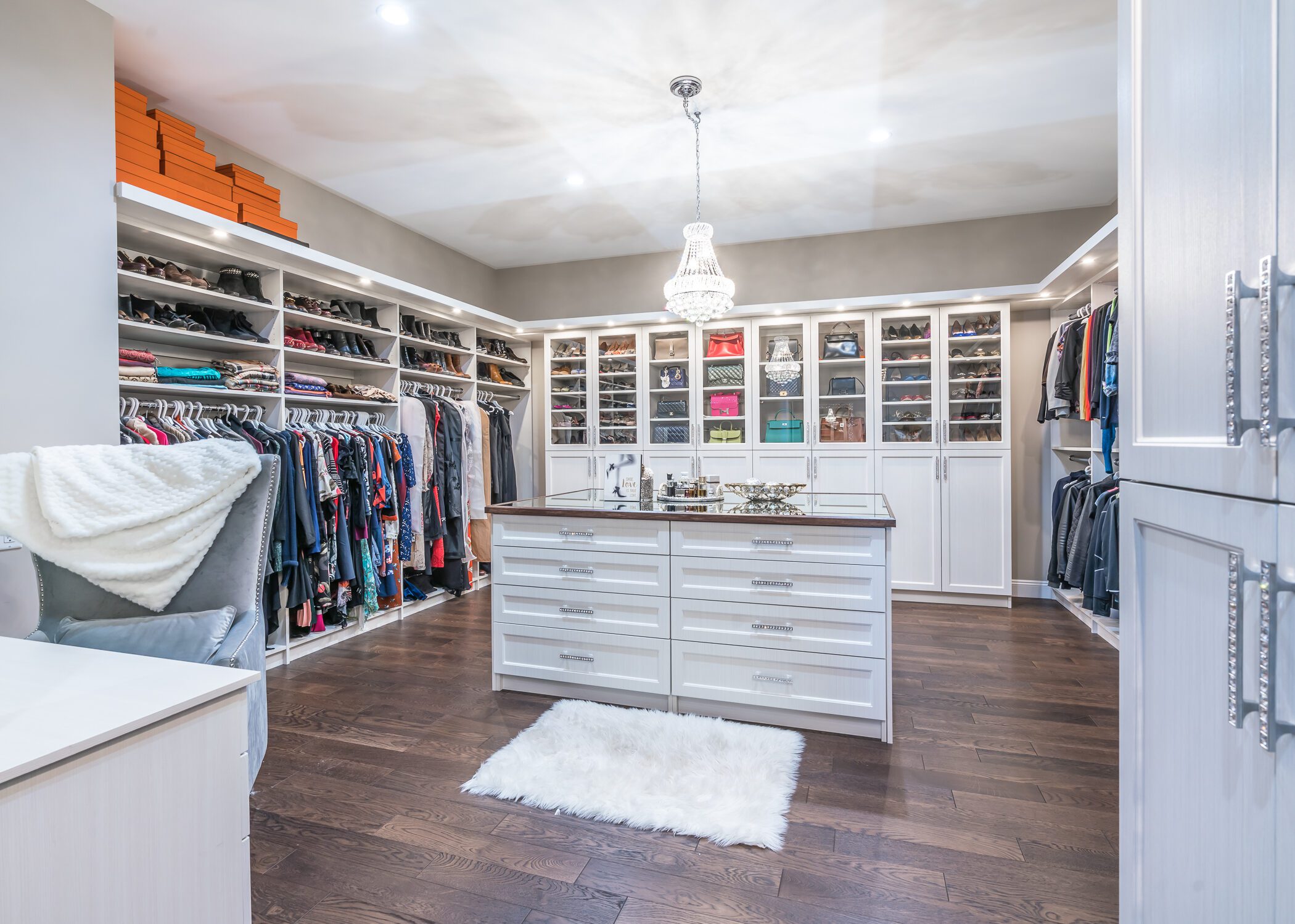 Spacious, luxurious walk-in closet with an island in the center